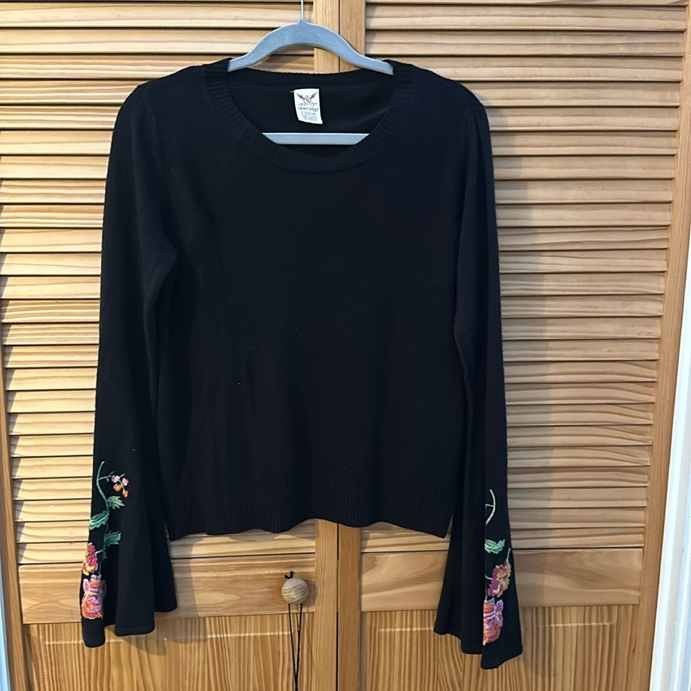 Flare sleeved black sweater with embroidered flower detail